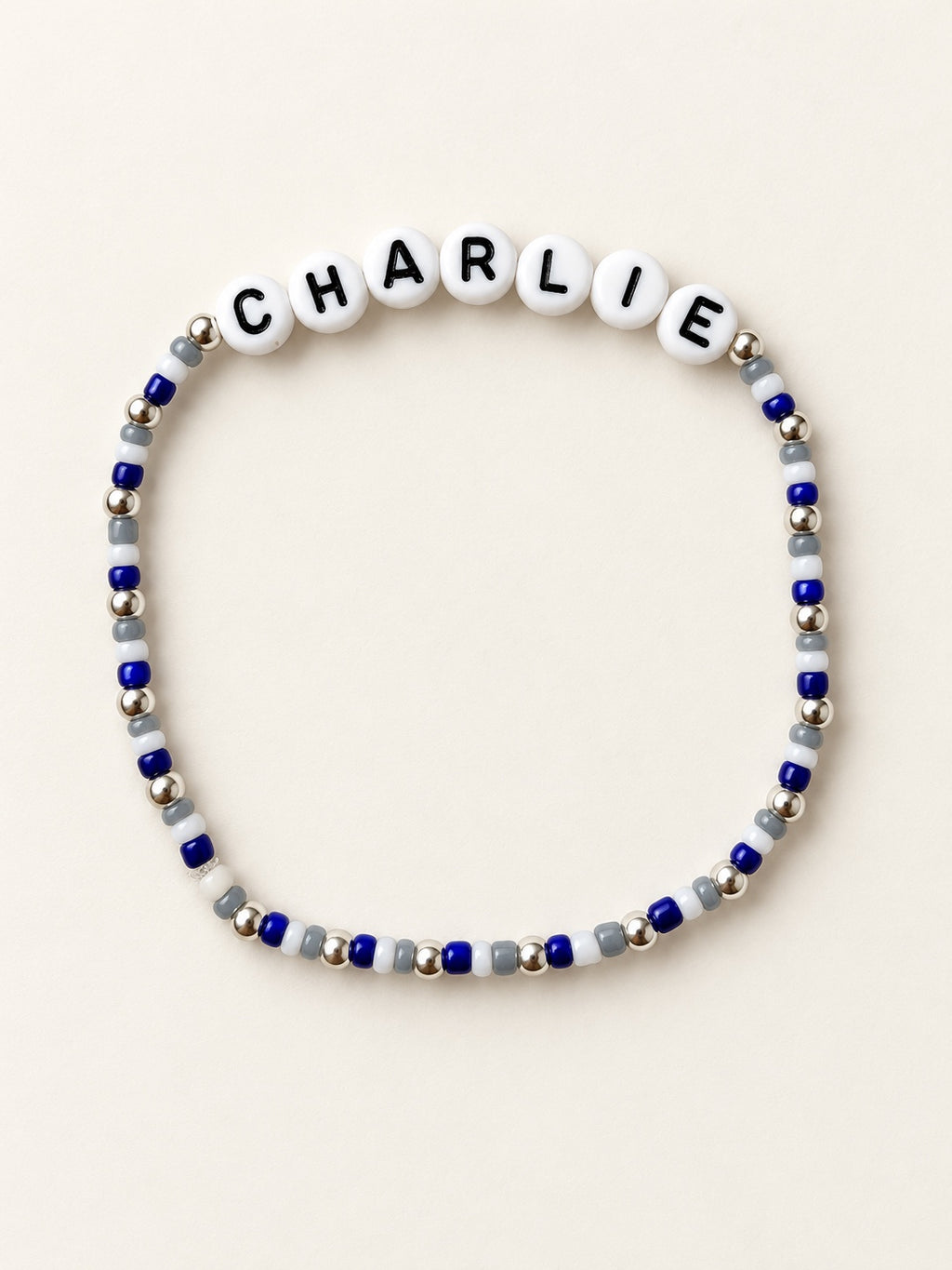 Custom name bracelet with blue, white, and silver beads