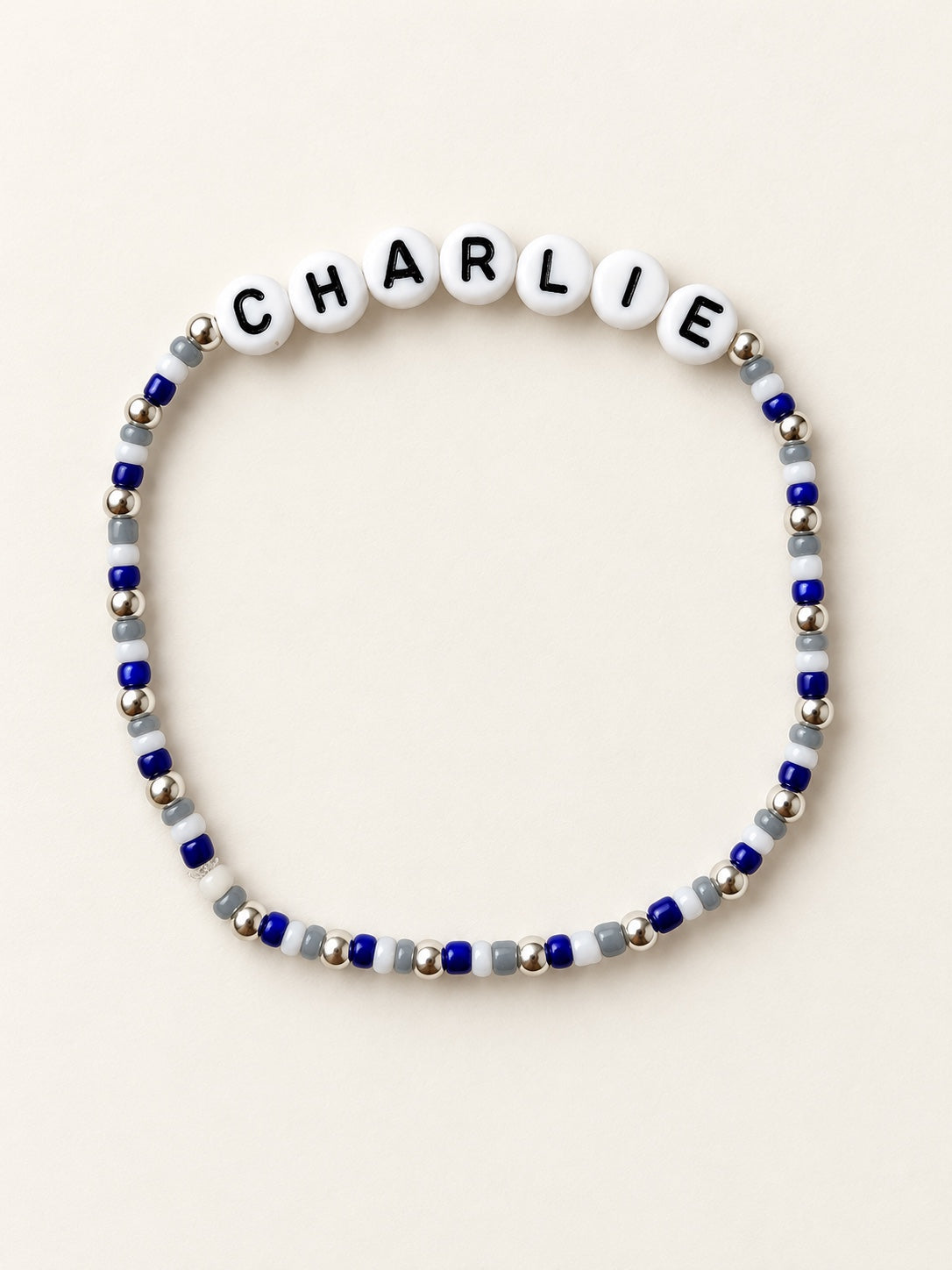 Custom name bracelet with blue, white, and silver beads