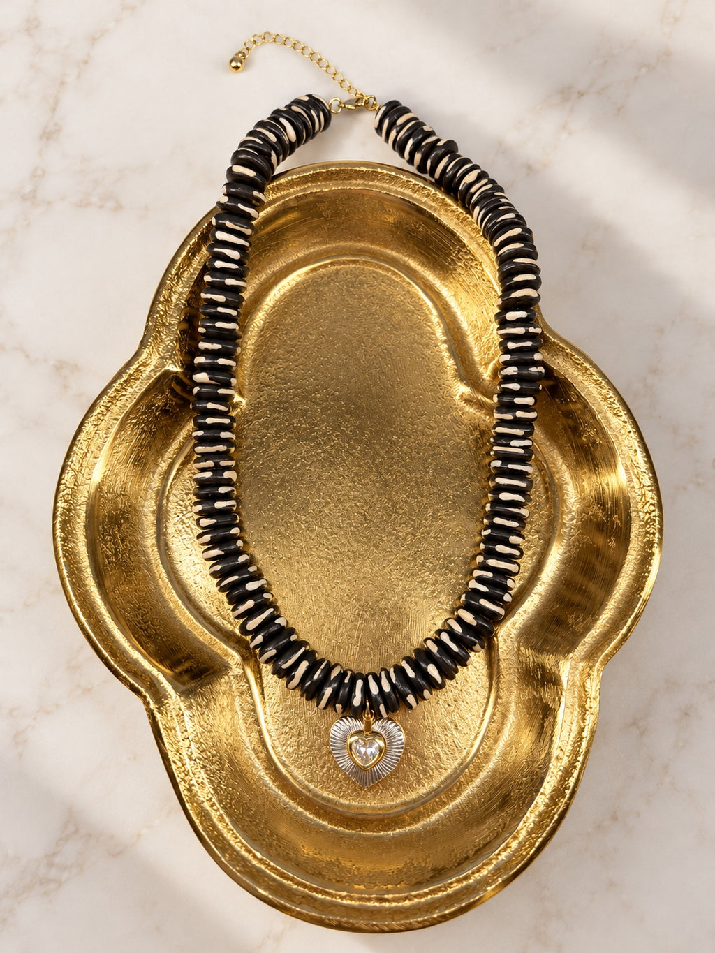 Zebra Necklace on gold shell dish