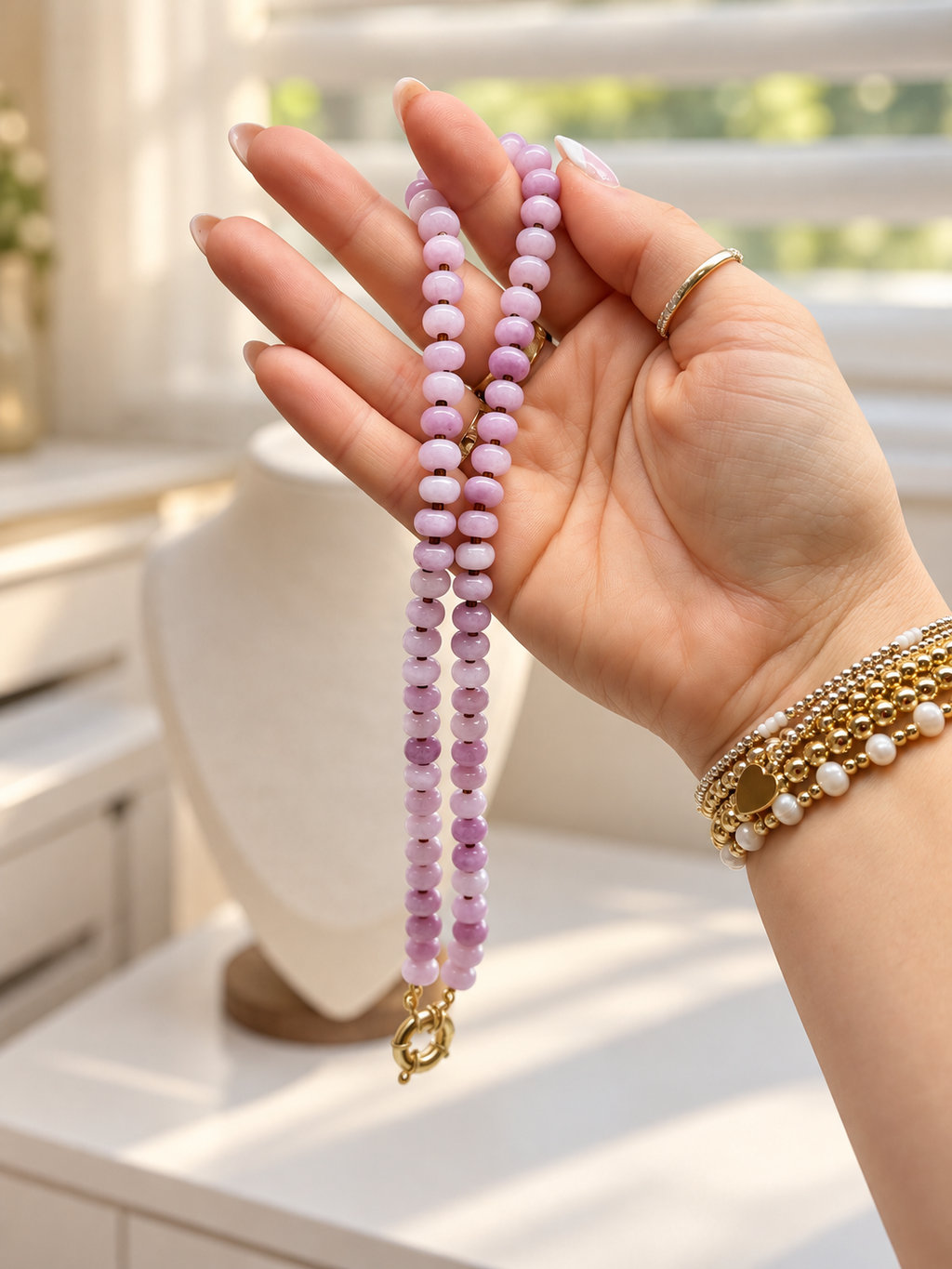 Close-up of The Rose Necklace held in hand