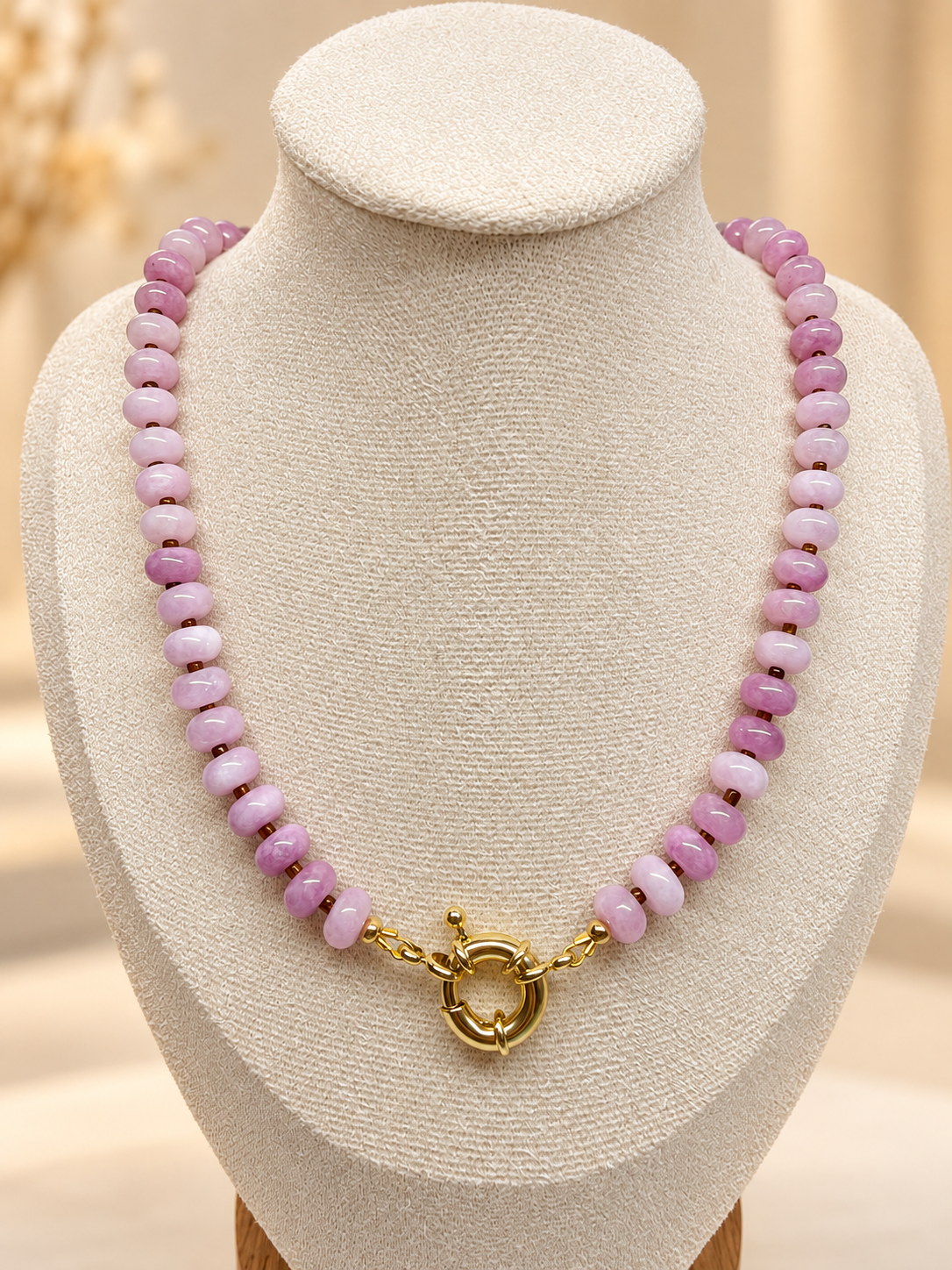 The Rose Necklace displayed on a cream bust