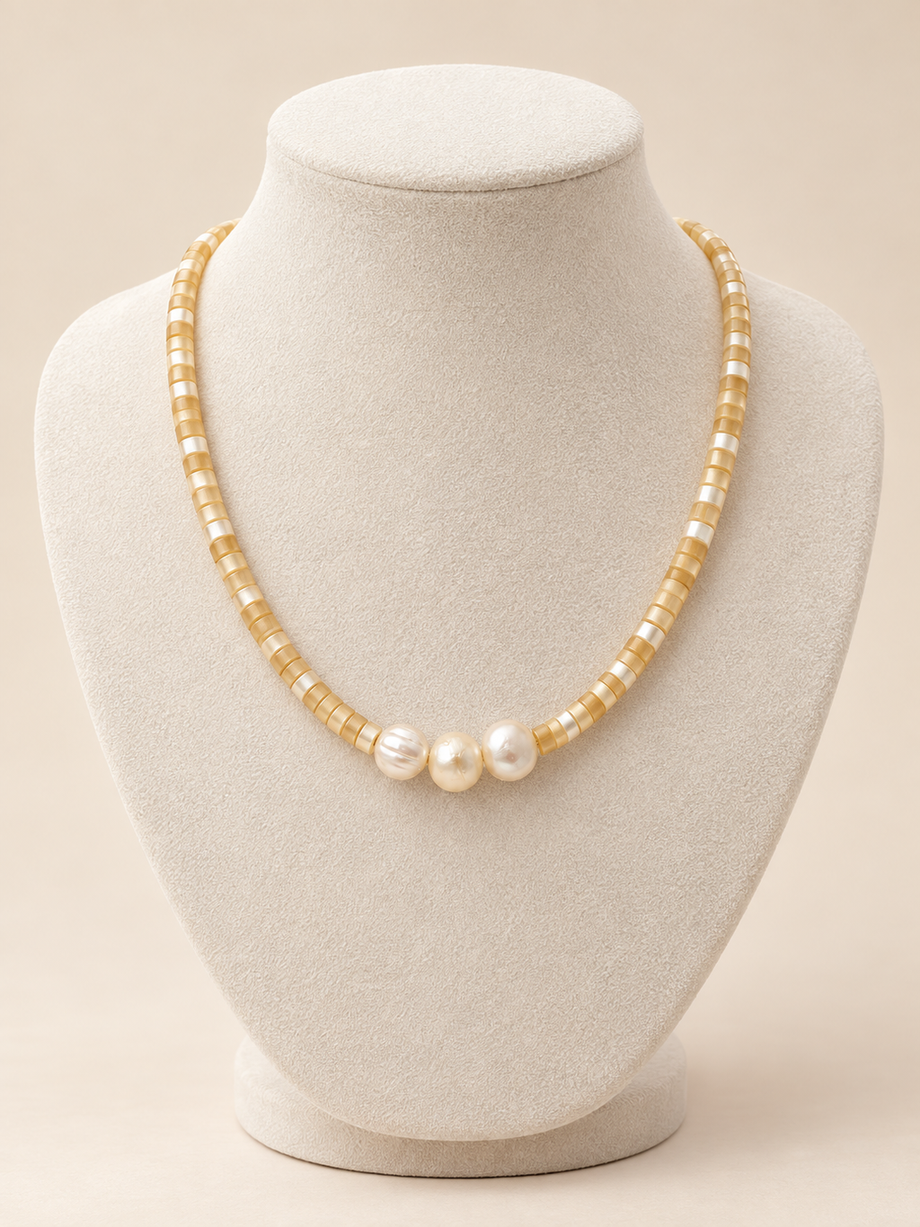 Golden Hour Pearl Necklace displayed on an ivory bust