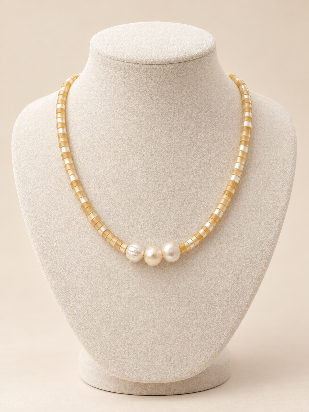 Golden Hour Pearl Necklace displayed on an ivory bust