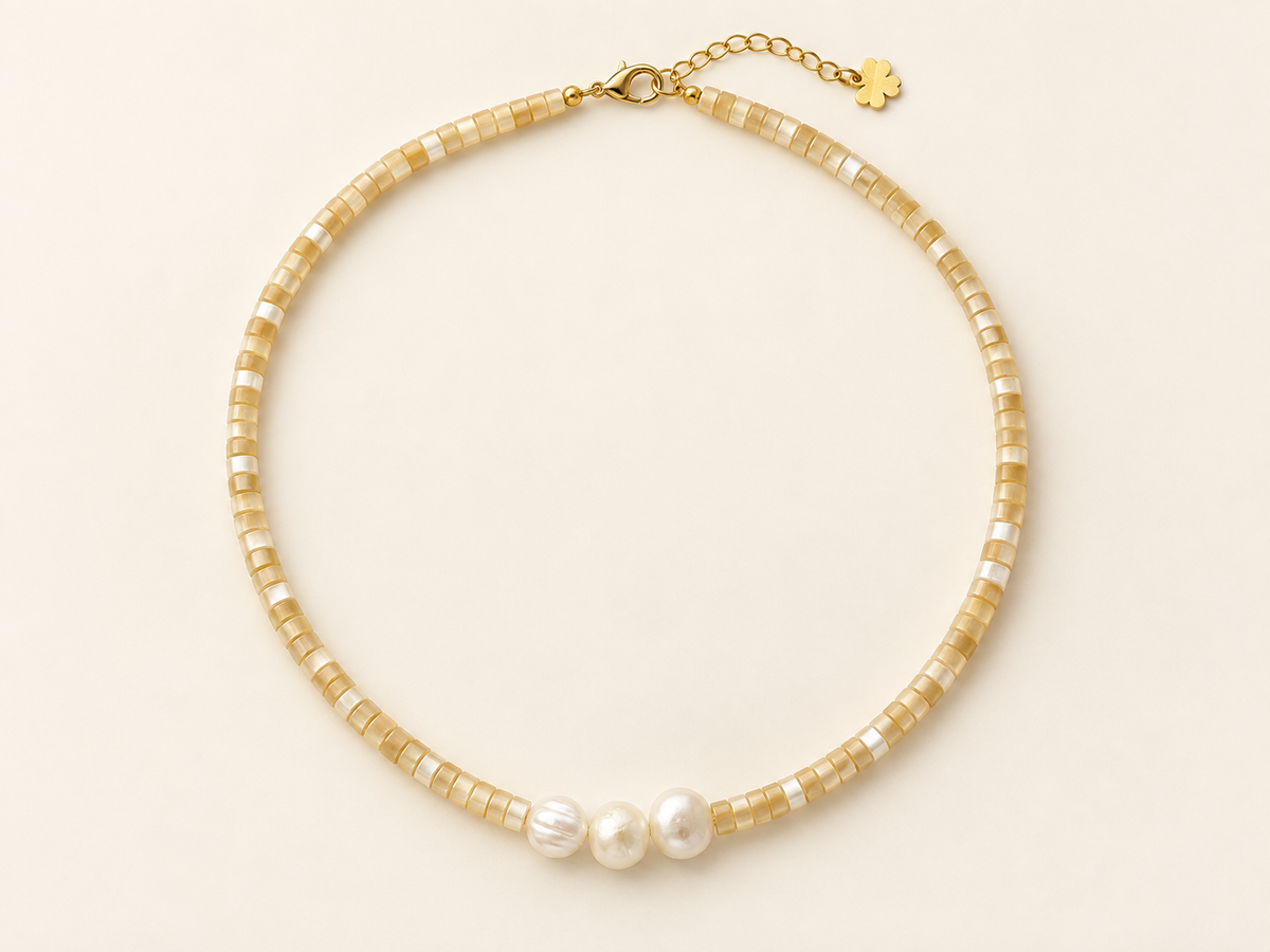 Golden Hour Pearl Necklace arranged in an oval on ivory background
