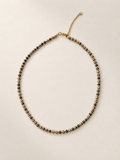 Mini Dalmatian necklace on a warm ivory boutique background