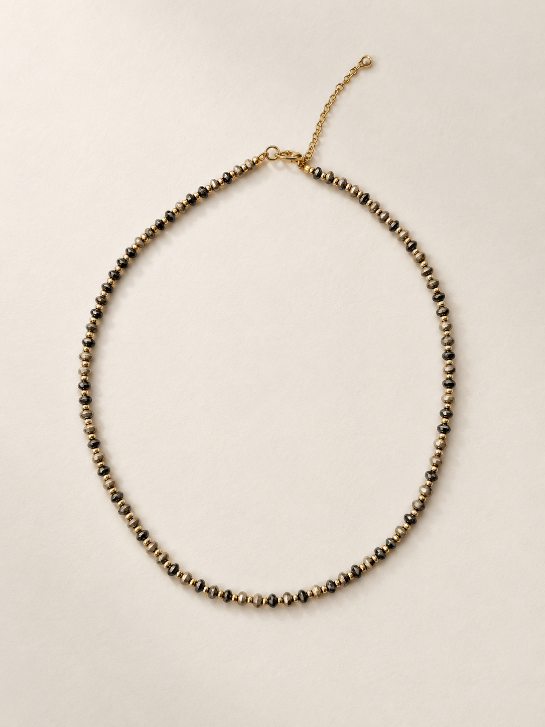 Mini Dalmatian necklace on a warm ivory boutique background