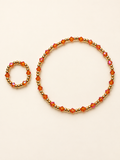 Topaz bracelet and matching ring on a clean ivory background