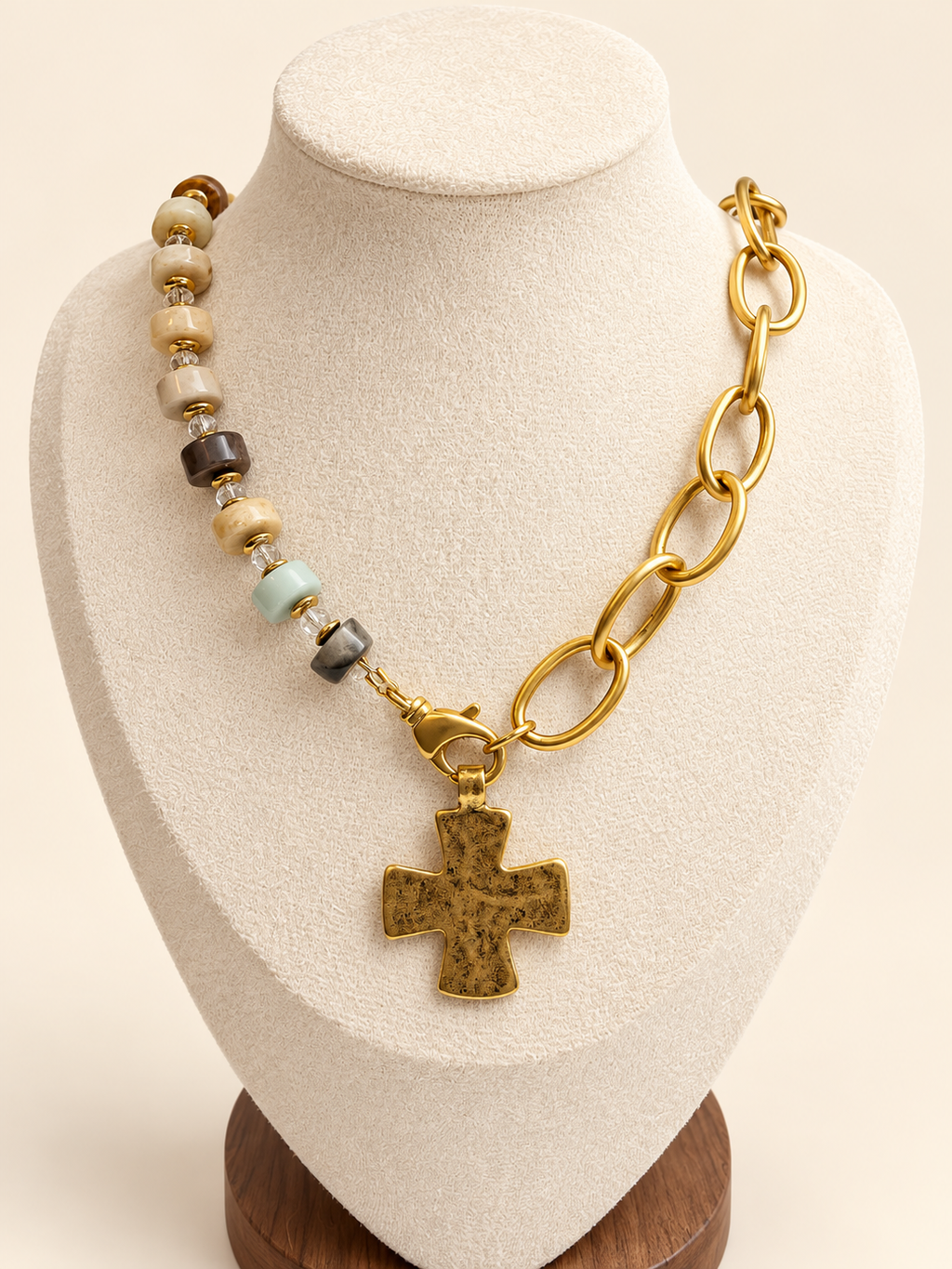 Golden Earth Link Necklace with optional cross charm on an ivory display bust