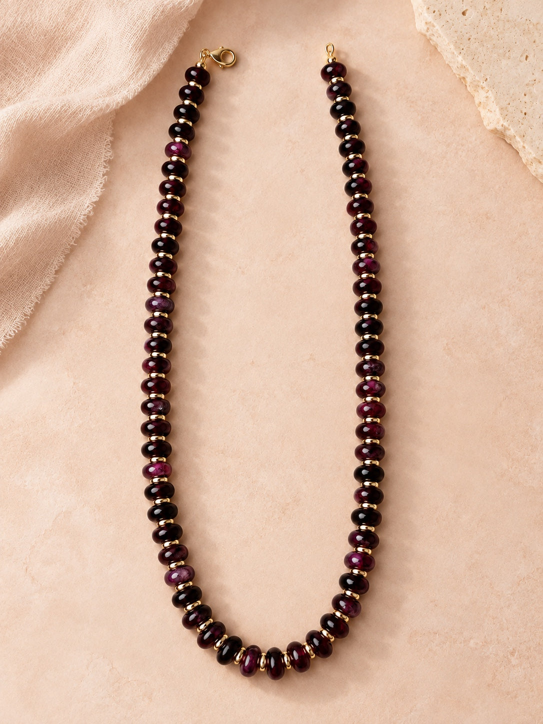 Merlot-toned beaded necklace with gold-tone spacer accents