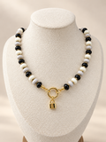 Midnight Muse Necklace displayed on a cream bust with a lock charm