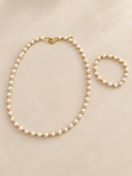 Pearl-style and gold-tone necklace with matching bracelet
