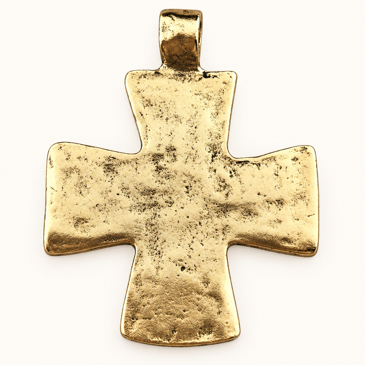 Single distressed gold-tone cross charm on off-white