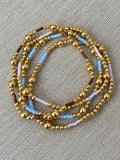 Sky, lilac, and mocha gold bead bracelets displayed together
