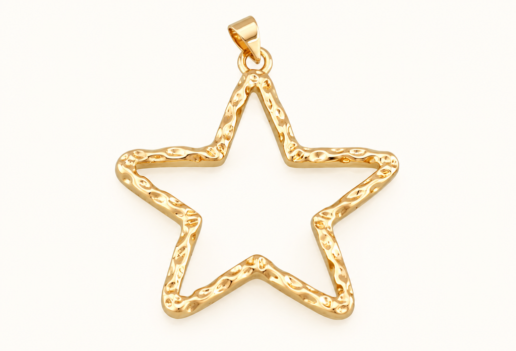 Single open gold-tone star charm on off-white