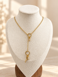 Gold-tone drop chain necklace on an ivory display bust