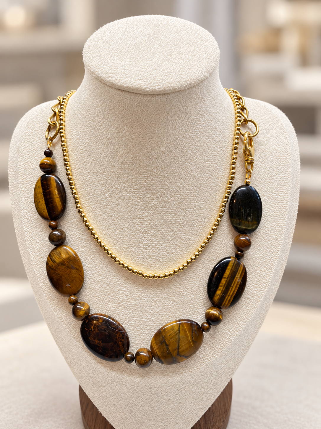 Tiger eye stone necklace layered with a gold beaded necklace