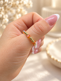 Topaz ring with gold-tone beads and amber crystal accents worn on hand