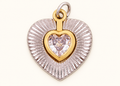 Single two-tone heart charm with a clear heart crystal on off-white